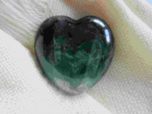 emerald heart on white cloth